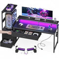 JIOABL Gaming Desk with RGB LED, Built-in Charging Station, Ergonomic Monitor Stand, Storage Drawers, Reversible Shelf, for Teens & Adults